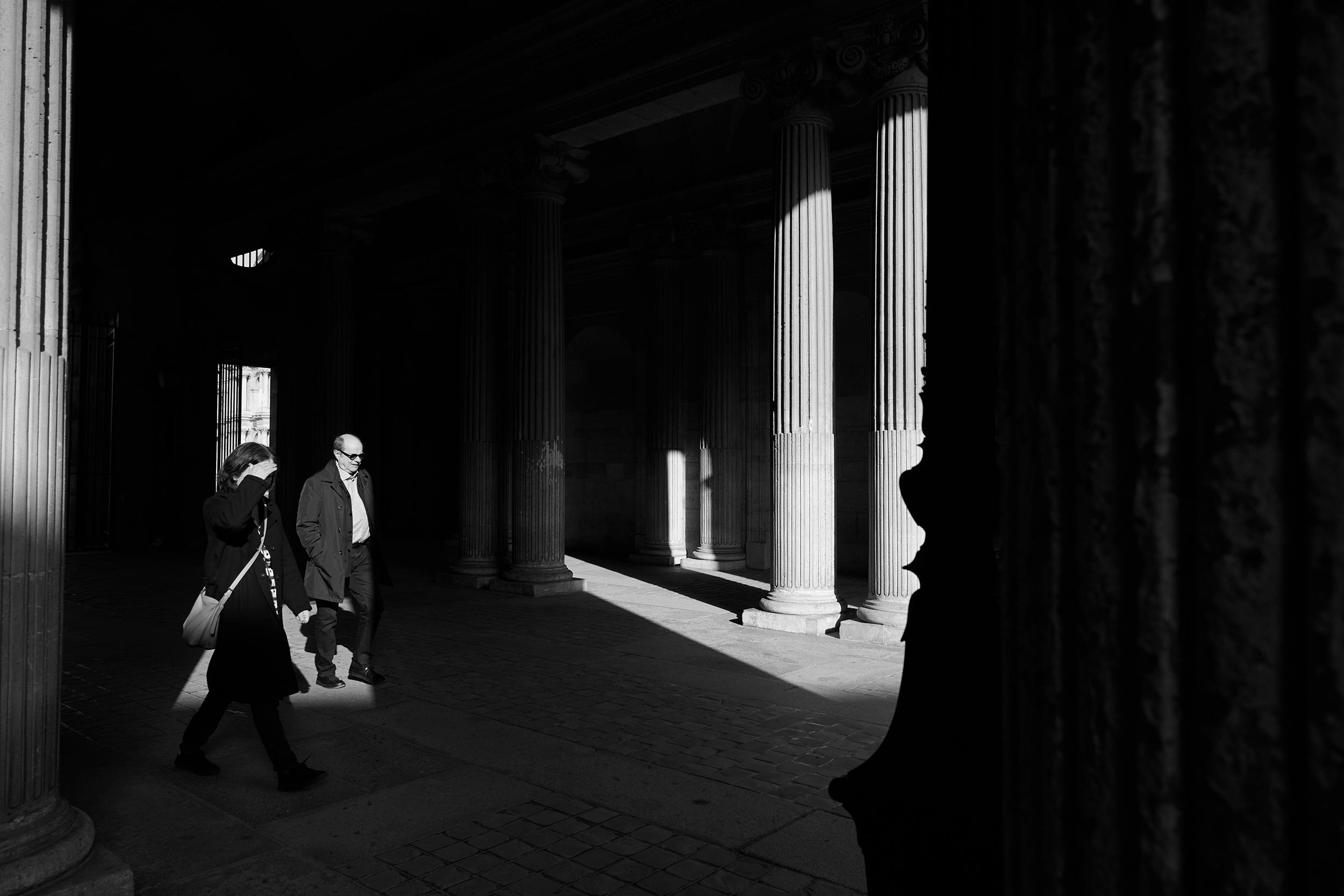 Paris - Visitors walk through the archways into the Cour Carrée at the Louvre.